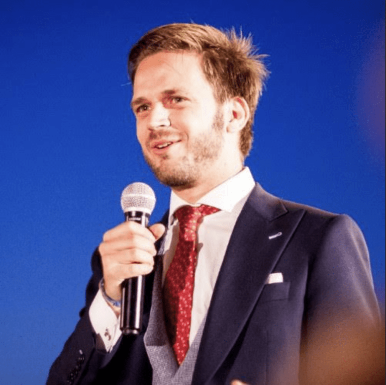 Mateo Zimmerman of Cemex Ventures speaking on stage against a blue background